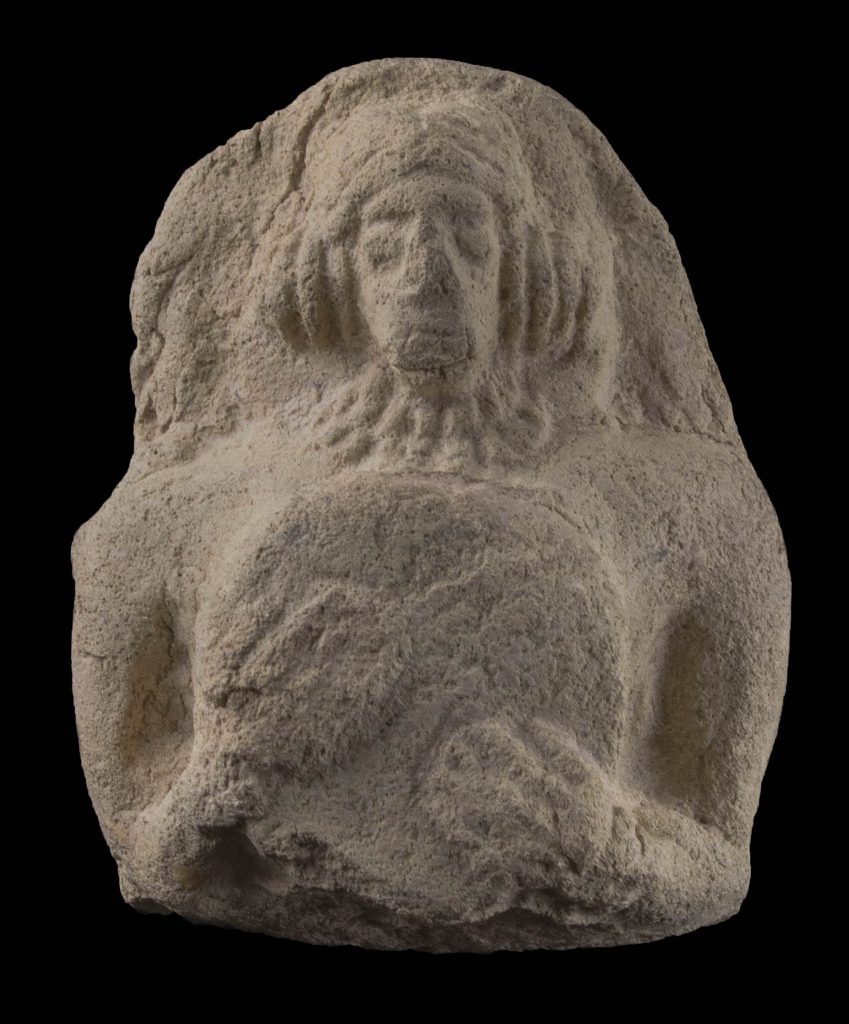 Image shows a fired clay figurine of a female holding a small drum against her breast.