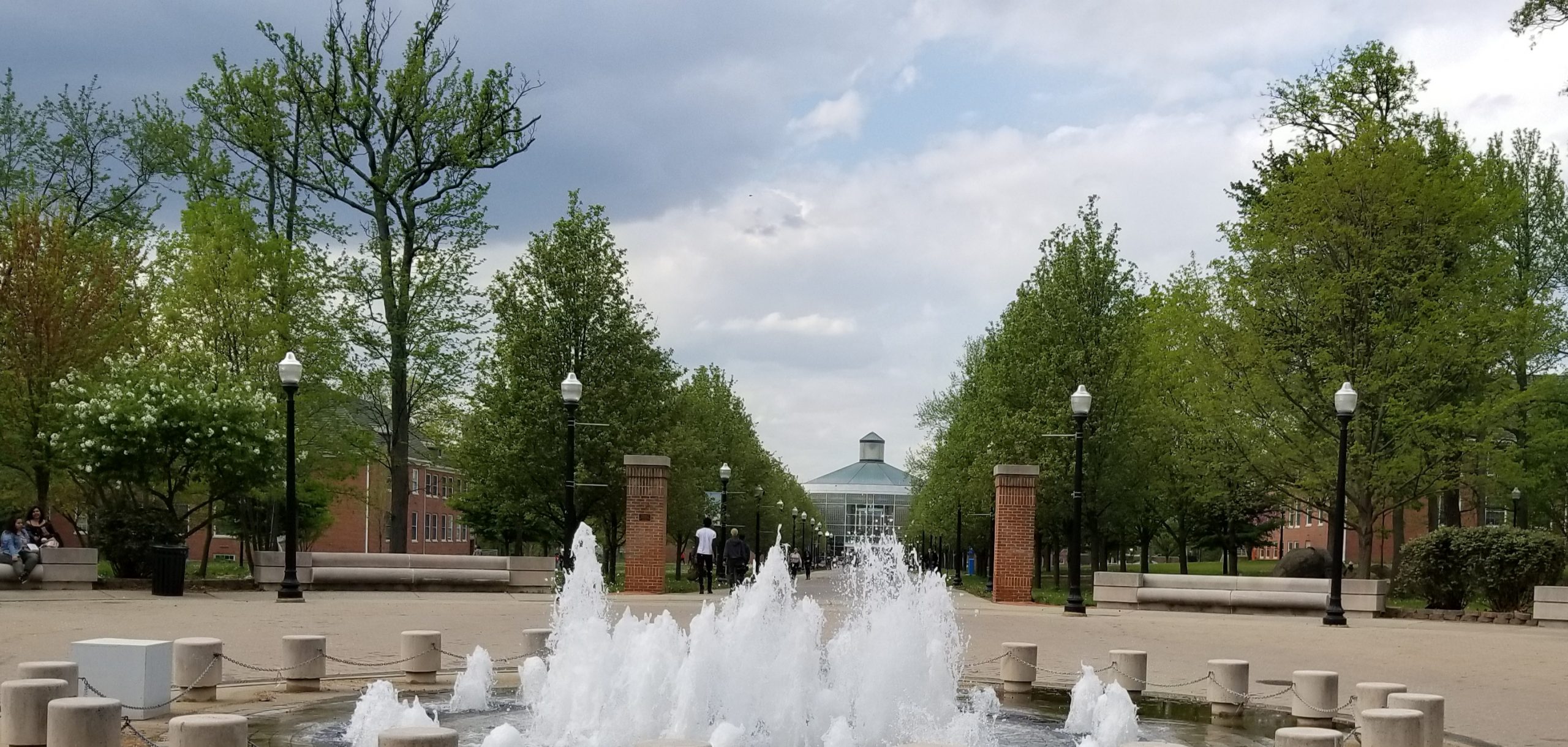 View of the College of Staten Island with a large fountain in the foreground.
