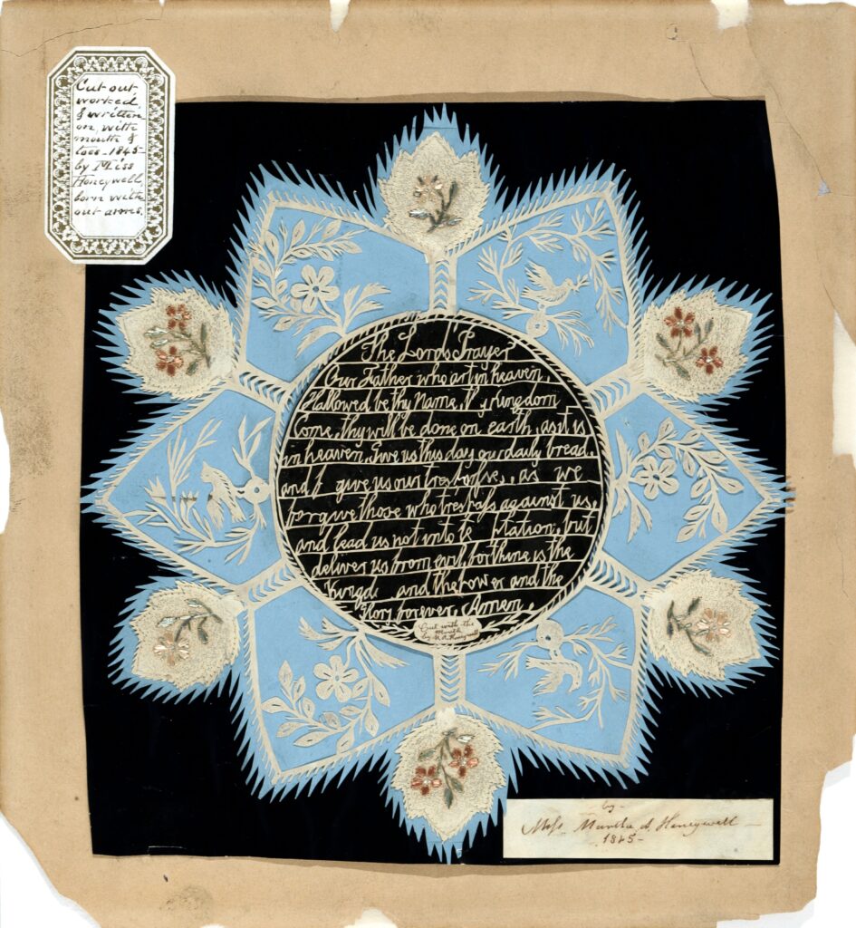 Star shaped paper cut largely in black, white and light blue with flower and bird motif and the Lord's Prayer written in the center. Note affixed to upper left corner reads "Cut out worked & written on with mouth and toes - 1845 - by Miss Honeywell, born without arms". Note affixed to lower right corners reads "by Miss Martha A. Honeywell 1845"