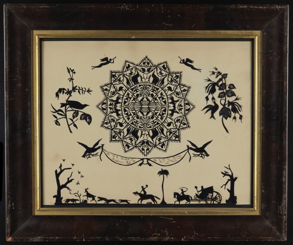 Black on white paper cut with central circular design flanked by angels, flora, and birds floating above trees and a scene of animals chased by figures on horseback and riding in carriage.